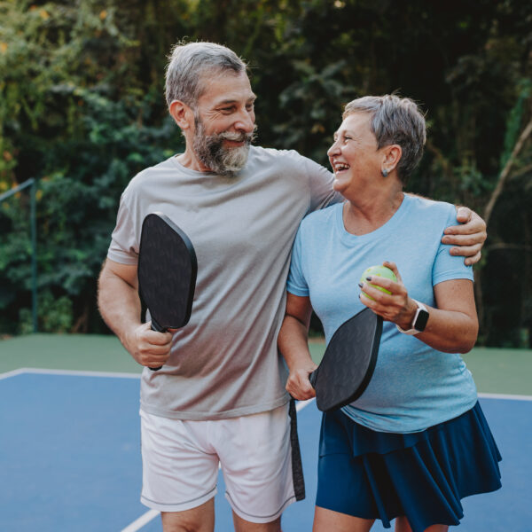 Senior couple playing pickleball