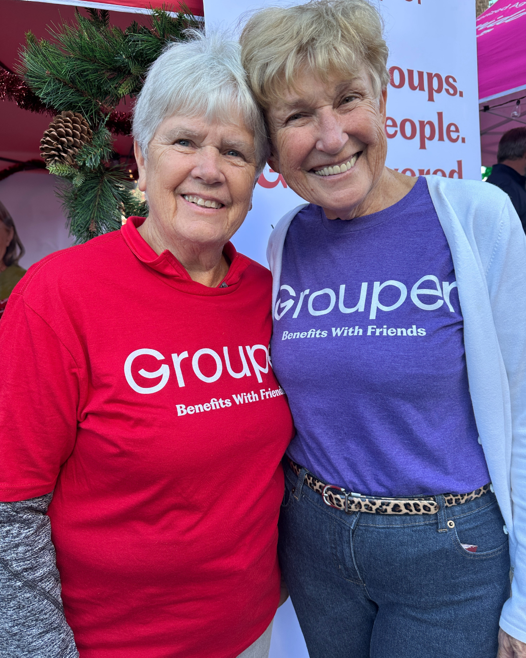 Two women in Grouper tee-shirts, smiling.