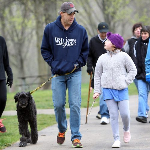 Dr David Sabgir walks his dog Mudge as he talks with nine year old Sophia Sturiano during the "Walk with a Doc" program at High Banks Metro Park on Saturday April 23.  Photo by Lorrie Cecil/ ThisWeek Community News