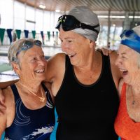 A real moment of joy and laughter with a group of senior athletes at the swimming pool.